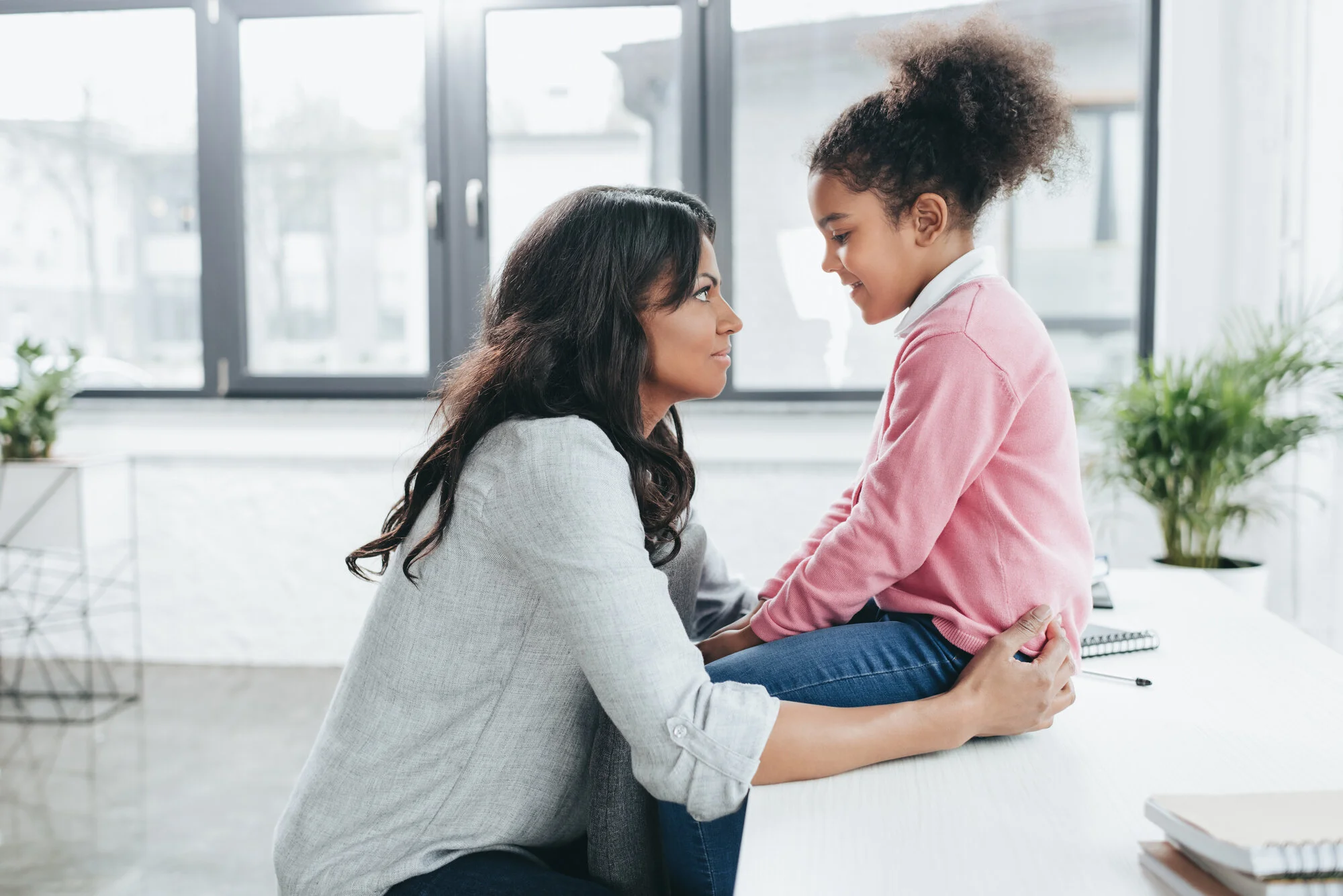 A mother listening and connecting with her young daughter
